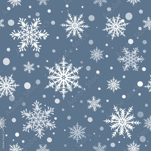 Ornamental snowflakes on grey background seamless pattern