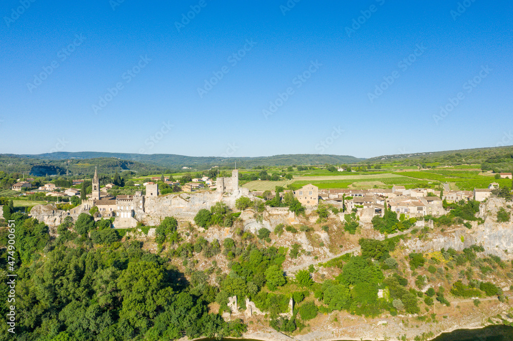 The panoramic view of the town of Aigueze and its green countryside in Europe, France, Ardeche, in summer, on a sunny day.