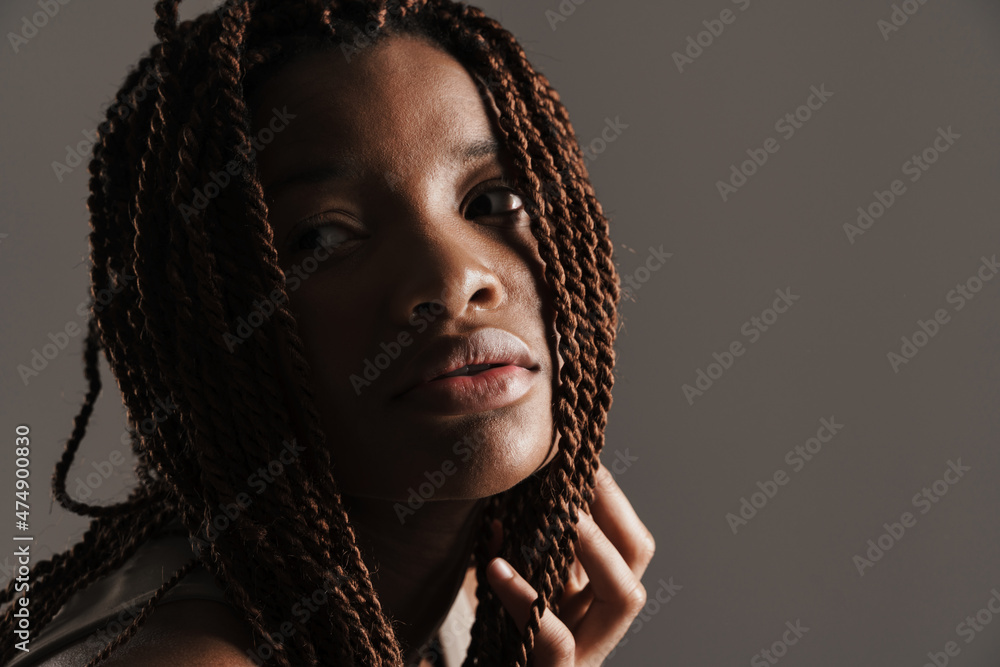 Young black woman with afro pigtails posing and looking aside