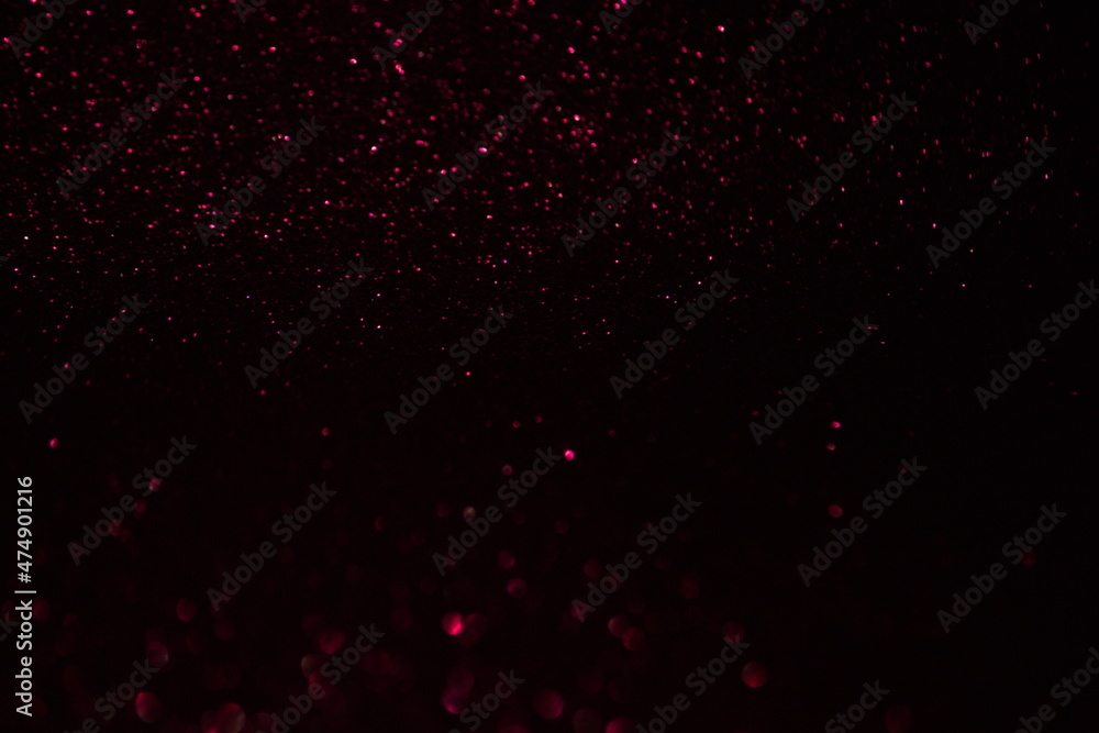 Glittering festive red and black background. Concept of New Year celebration. defocused blurred background Glittering festive red and black background. Concept of New Year celebration. defocused blurred background