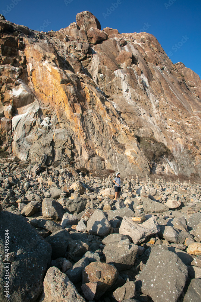 Morro Rock Giant Boulder at Morro Bay, California, with Stacked Rock Cairns Built by Visitors as a Spiritual Connection of Togetherness Morro Rock Giant Boulder at Morro Bay, California, with Stacked Rock Cairns Built by Visitors as a Spiritual Connection of Togetherness
