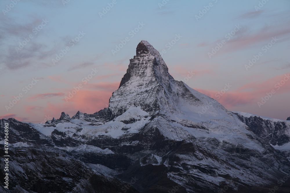 Pink morning sky over unique Mount Matterhorn.