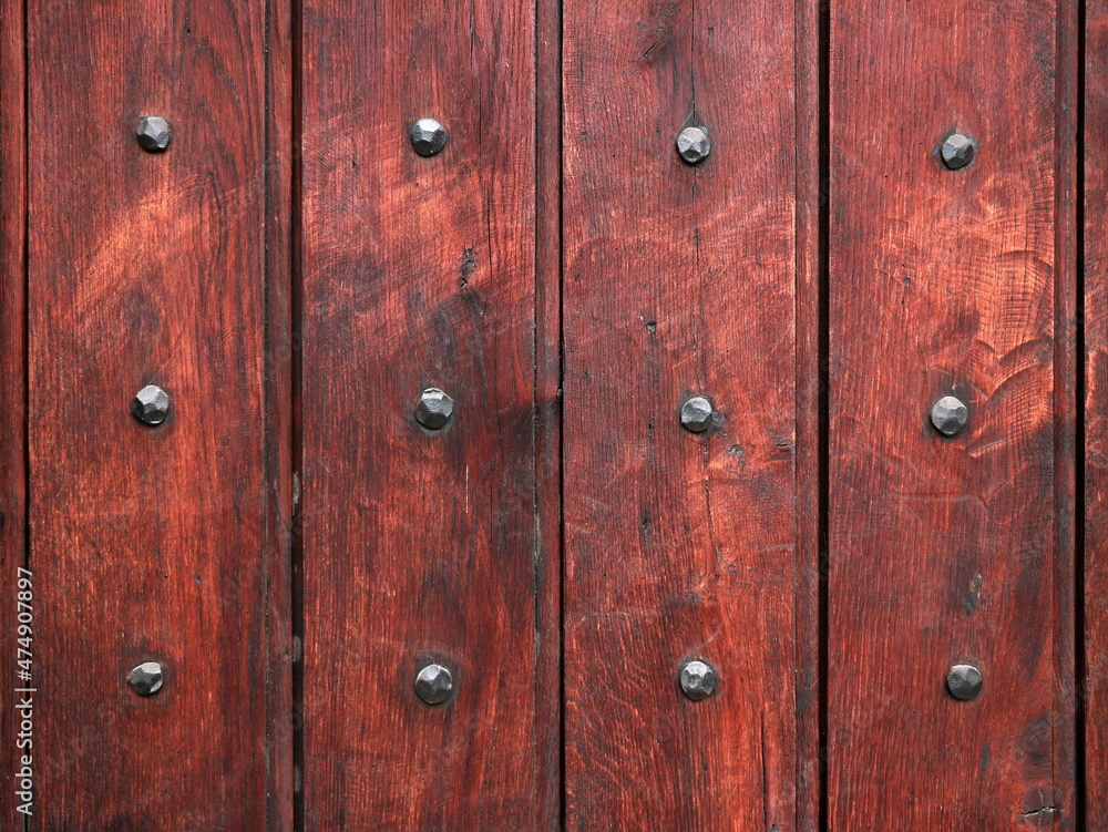 Part of wooden door with old metal nails