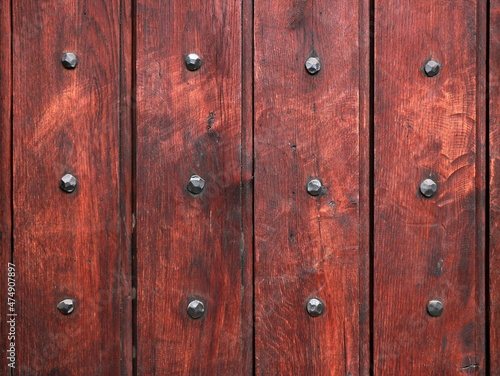 Part of wooden door with old metal nails
