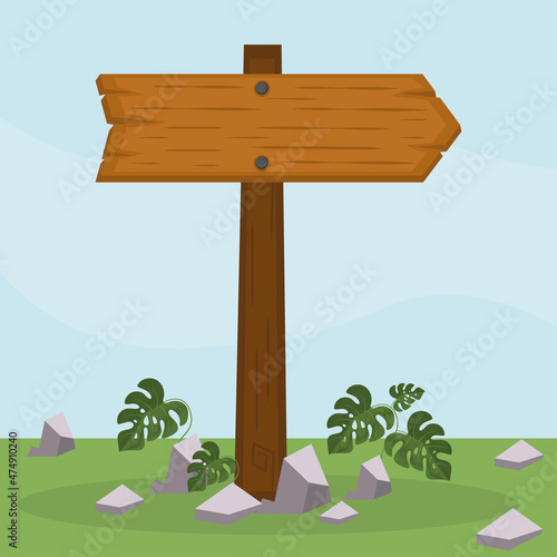 wooden signpost on grass