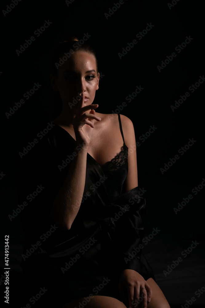 portrait of a beautiful woman in black silk underwear in the dark portrait of a beautiful woman in black silk underwear in the dark