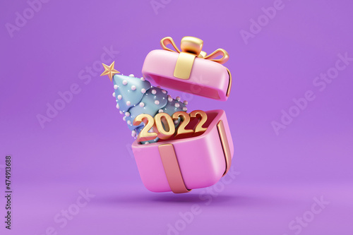 Cartoon Christmas Tree with Candy and 2022 Gold Text inside of Gift Box on purple studio background photo