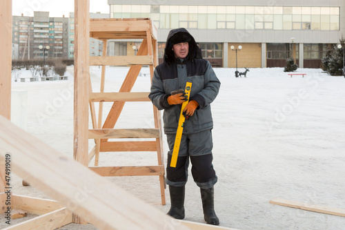 Worker assembling the frame of a wooden slide