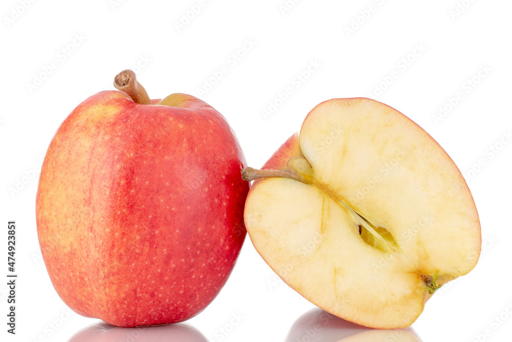 One half and one whole organic red apples, close-up, isolated on white. One half and one whole organic red apples, close-up, isolated on white.