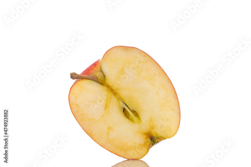 One half of an organic red apple, close-up, isolated on white.