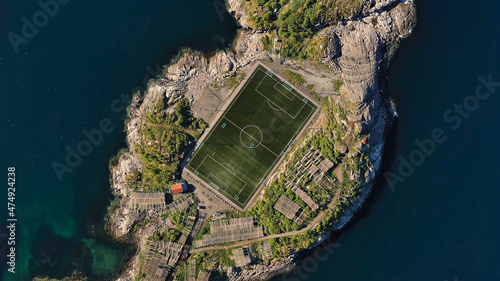 Amazing nature of Lofoten Islands, Norway By Drone top view stadium surrounded by norway lake green sport football traditional district in the county of Nordland breathtaking scandinavian soccer photo