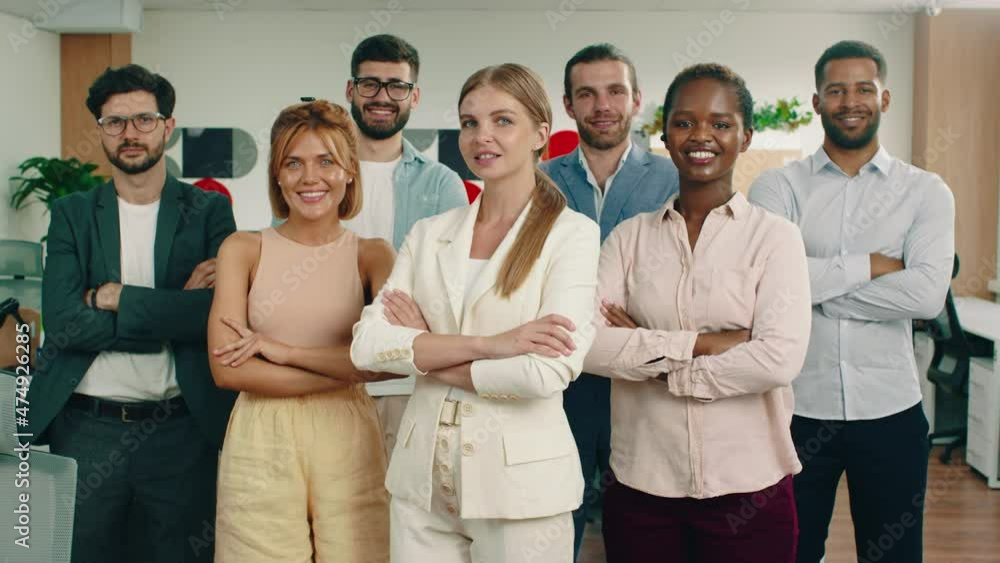 A group of workers are staring directly at the camera while having their arms folded and standing in a formation with a beautiful woman in the front. Arri Alexa Mini. A group of workers are staring directly at the camera while having their arms folded and standing in a formation with a beautiful woman in the front. Arri Alexa Mini.
