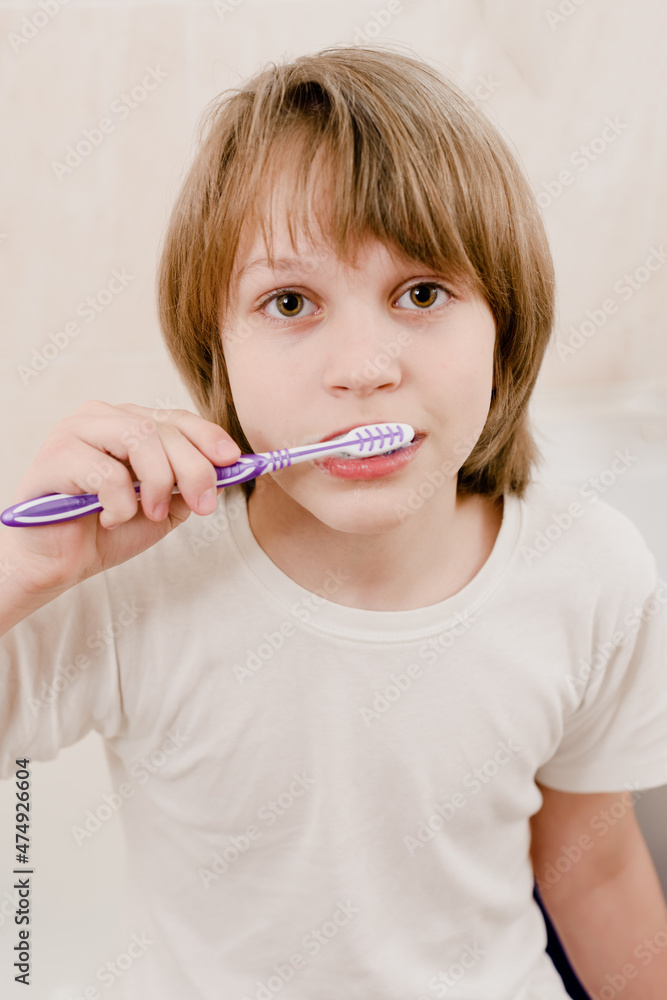 Portrait of young boy with toothbrush cleaning teeth in the morning Portrait of young boy with toothbrush cleaning teeth in the morning