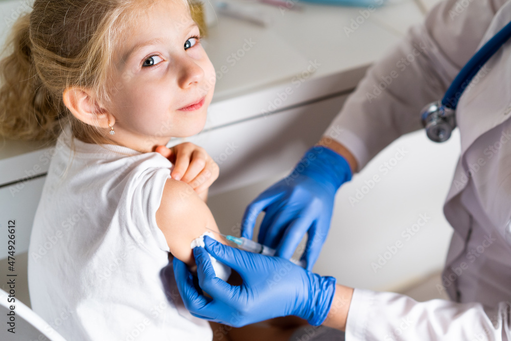 vaccination of children, a little girl at a doctor's appointment, an injection in the arm, the conce vaccination of children, a little girl at a doctor's appointment, an injection in the arm, the conce