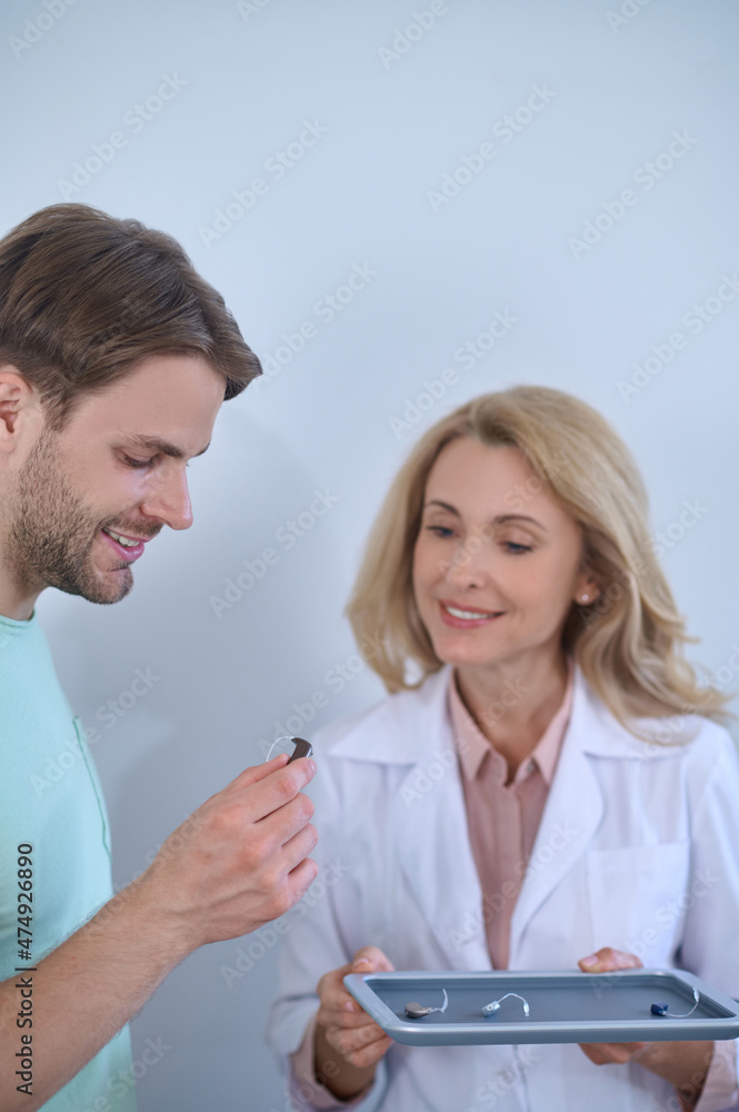 Woman with hearing aids and man choosing Woman with hearing aids and man choosing