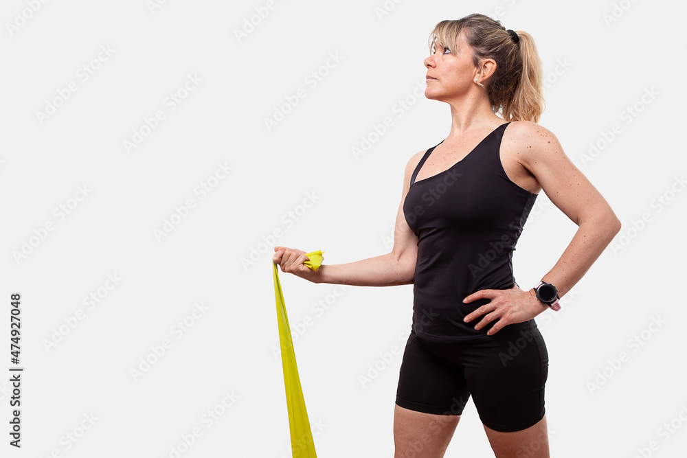 beautiful mature woman training with an elastic band on white background in studio beautiful mature woman training with an elastic band on white background in studio