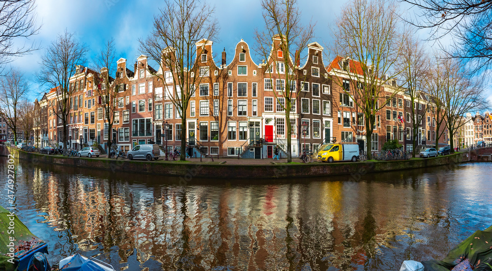 Panorama of sunny Amsterdam canal Leidsegracht with typical dutch houses, Holland, Netherlands.