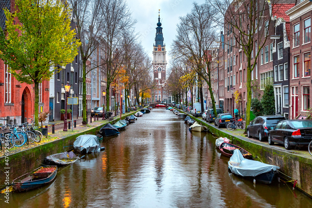 Rainy Amsterdam canal Groenburgwal with Zuiderkerk, southern church, Holland, Netherlands.