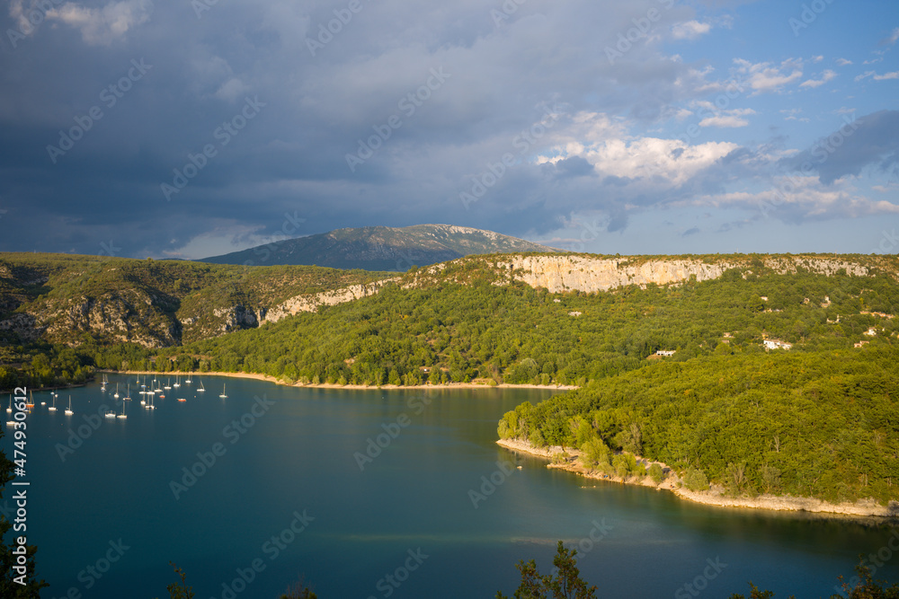 The edge of the lake of Sainte Croix and its forests towards Bauduen in Europe, in France, Provence Alpes Cote dAzur, in the Var, in the summer, on a sunny day.