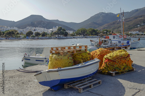 Picturesque landscape scenic view of Greek Island coastal town city of Amorgos Island in Greece with historic ancient old city skyline house building facades, rocks beach overlooking bay