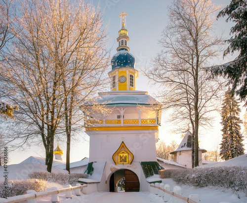 Tower above the entrance to  Holy Dormition Pskovo Pechersky Male Monastery in the town of Pechora, Pskov Region, Russia, on a winter day