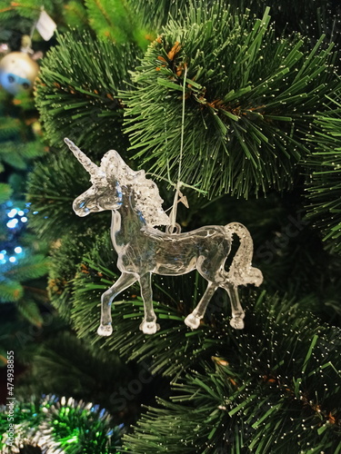 Christmas toy unicorn hanging on a Christmas tree 