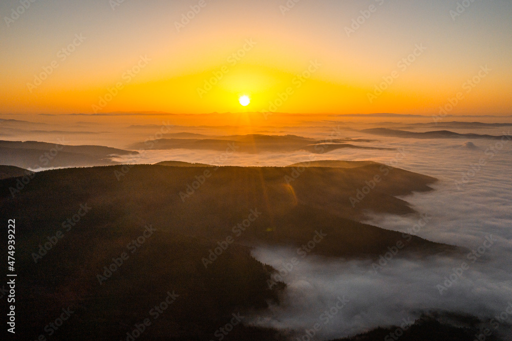 Beautiful landscape in the mountains at sunrise. View of foggy hills covered by forest. Beautiful landscape in the mountains at sunrise. View of foggy hills covered by forest.