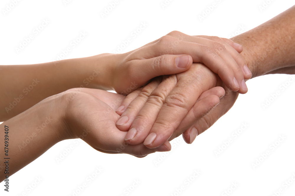 Young and elderly women holding hands together on white background, closeup Young and elderly women holding hands together on white background, closeup