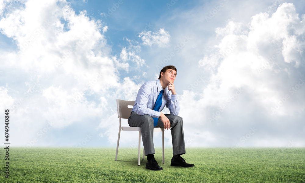 Young businessman sitting on an office chair Young businessman sitting on an office chair