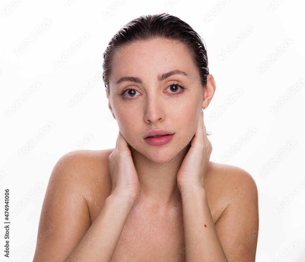 Beautiful face of young woman with clean fresh skin. Beauty portrait of brunette standing on white background copy space Beautiful face of young woman with clean fresh skin. Beauty portrait of brunette standing on white background copy space