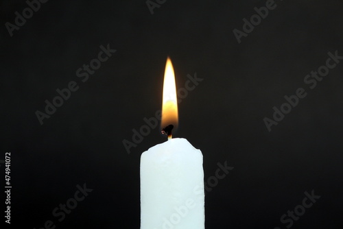 Candle flame on a black background. The fire is burning.