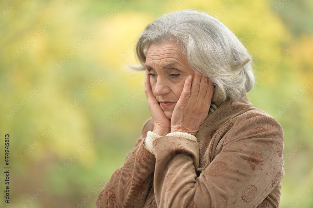 sad, thoughtful senior woman in park sad, thoughtful senior woman in park
