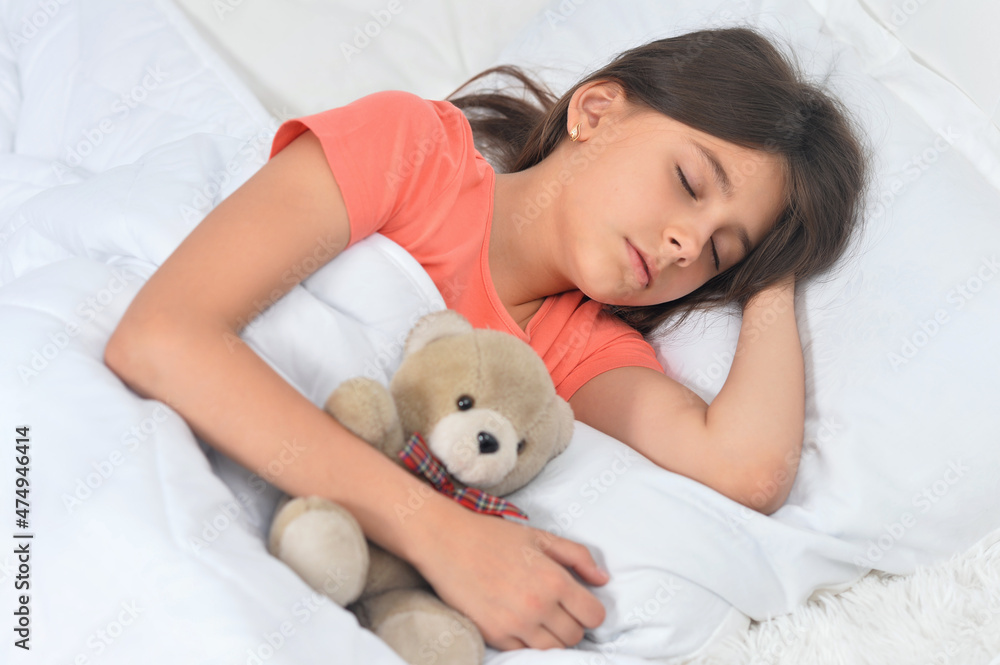 Cute little girl sleeping in bed with teddy bear Cute little girl sleeping in bed with teddy bear