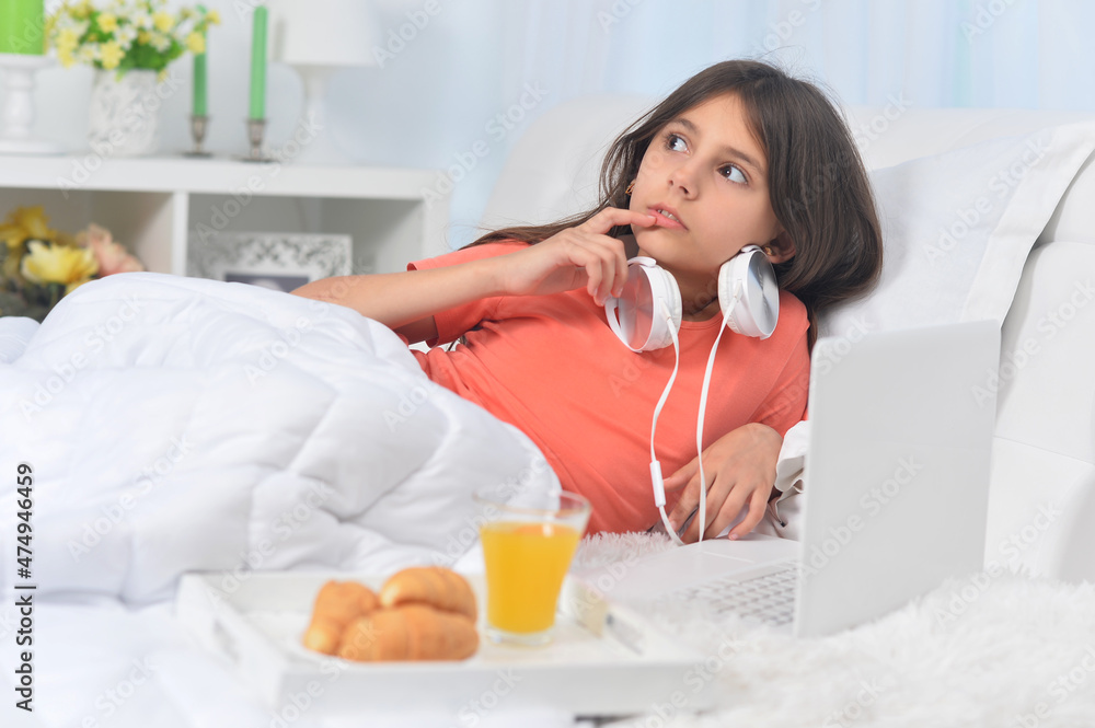 Beautiful girl with laptop and having breakfast Beautiful girl with laptop and having breakfast