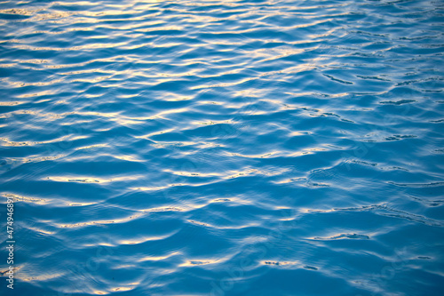 Closeup seascape surface of blue sea water with small ripple waves