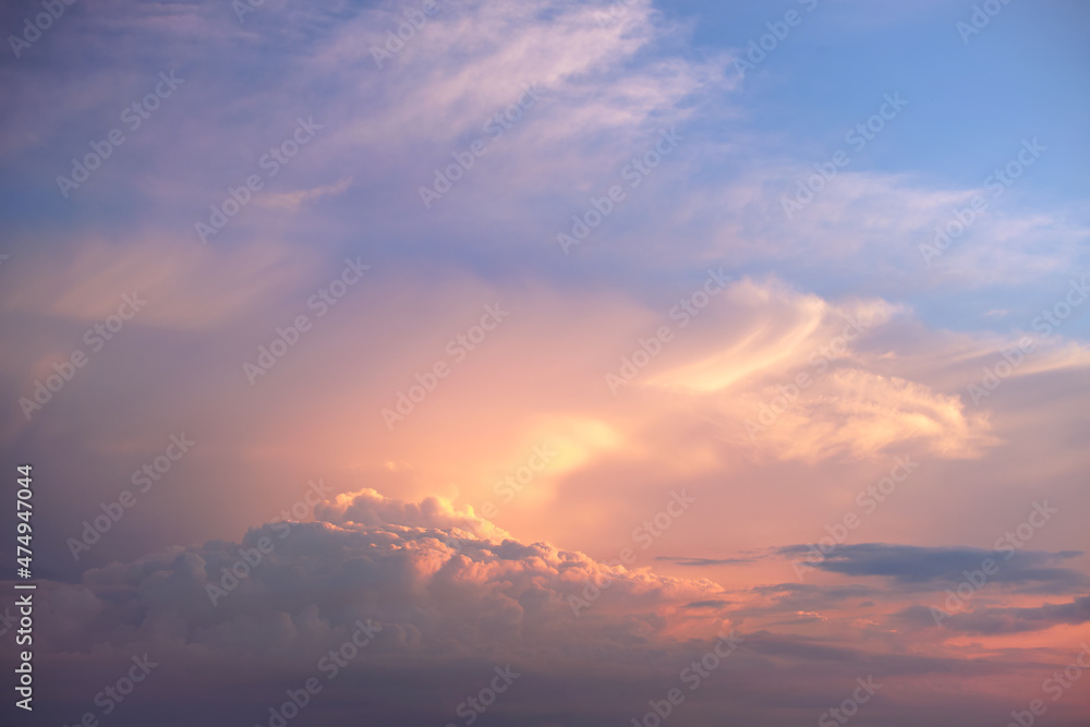 Colorful evening landscape with soft pastel coloured cloudscape on watercolor tinted sunset sky. Abstract nature background