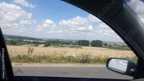 A view of fields through a car window