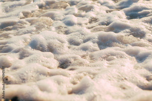 White wave splash on the pebble beach