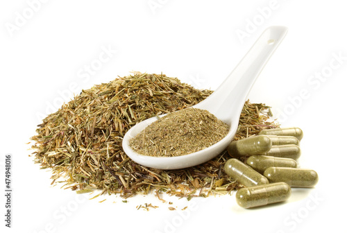 Dried Centaury Leaves with Powder and Capsules. Milled Bitter Substance isolated on white Background. photo