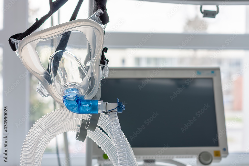 Non-invasive ventilation face mask, on background medical ventilator in ICU  in hospital. Photos | Adobe Stock