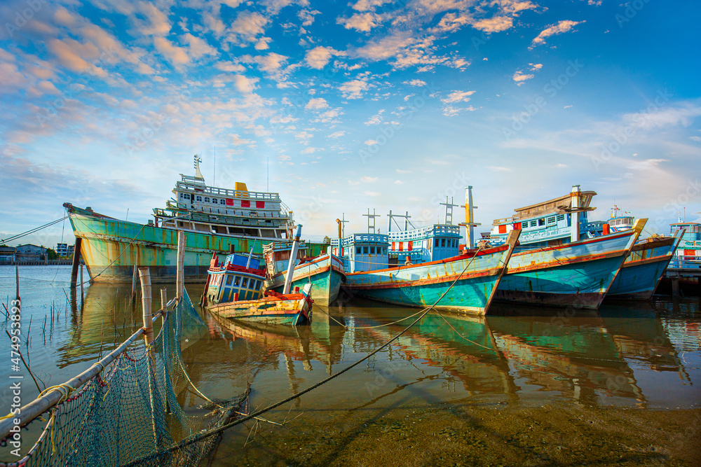 Fototapeta premium Many boats moored in sunrise morning time at Chalong port, Main port for travel ship to krabi and phi phi island, Phuket, Thailand