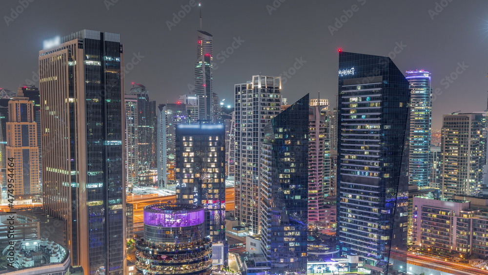 Dubai Marina Skyline with JLT district skyscrapers on a background aerial all night timelapse. Dubai Marina Skyline with JLT district skyscrapers on a background aerial all night timelapse.