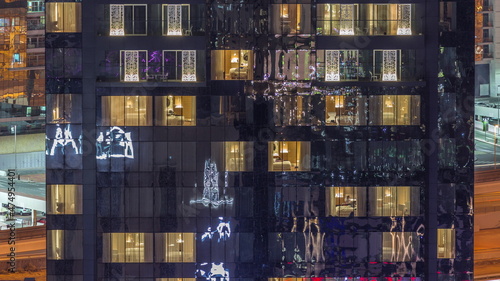 Windows lights in modern towers and residential buildings timelapse at night