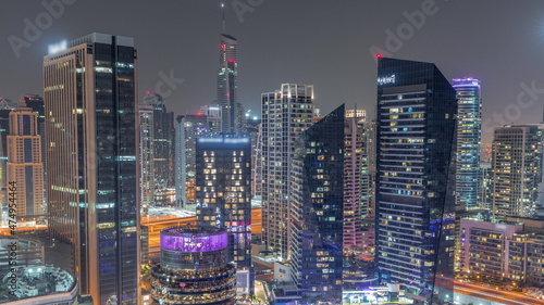 Dubai Marina Skyline with JLT district skyscrapers on a background aerial all night timelapse.