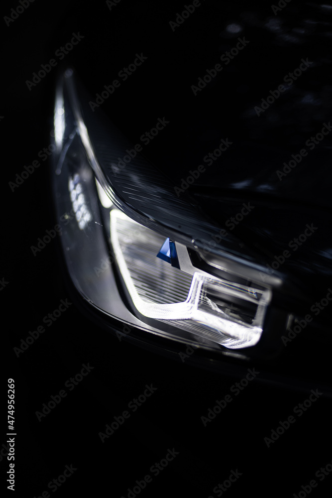 Detail close up view of the LED adaptive head light of premium luxury sedan car. Automotive lighting technology detail.