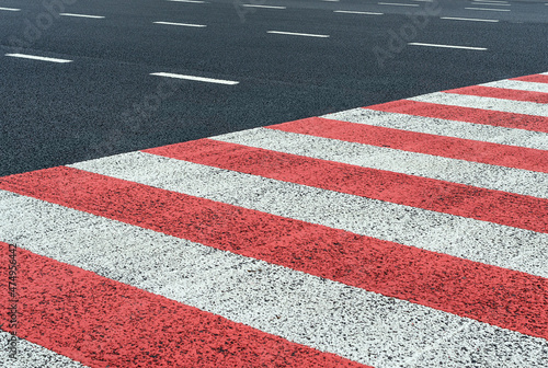 Red and white lines marking the pedestrian crossing
