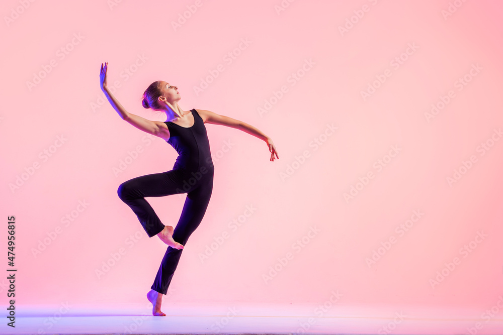 Young teenager dancer dancing on a red studio background. Ballet, dance, art, modernity, choreography concept - obrazy, fototapety, plakaty 