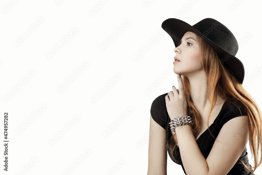 girl in a black hat looking away.