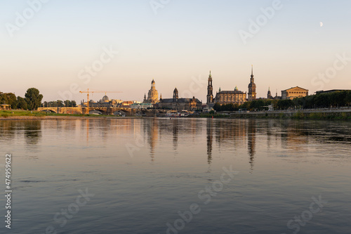 Cityscape of the historic old town in Dresden with reflections in the Elbe river. Beautiful city in Saxony in the evening sunlight. The famous buildings forming the skyline