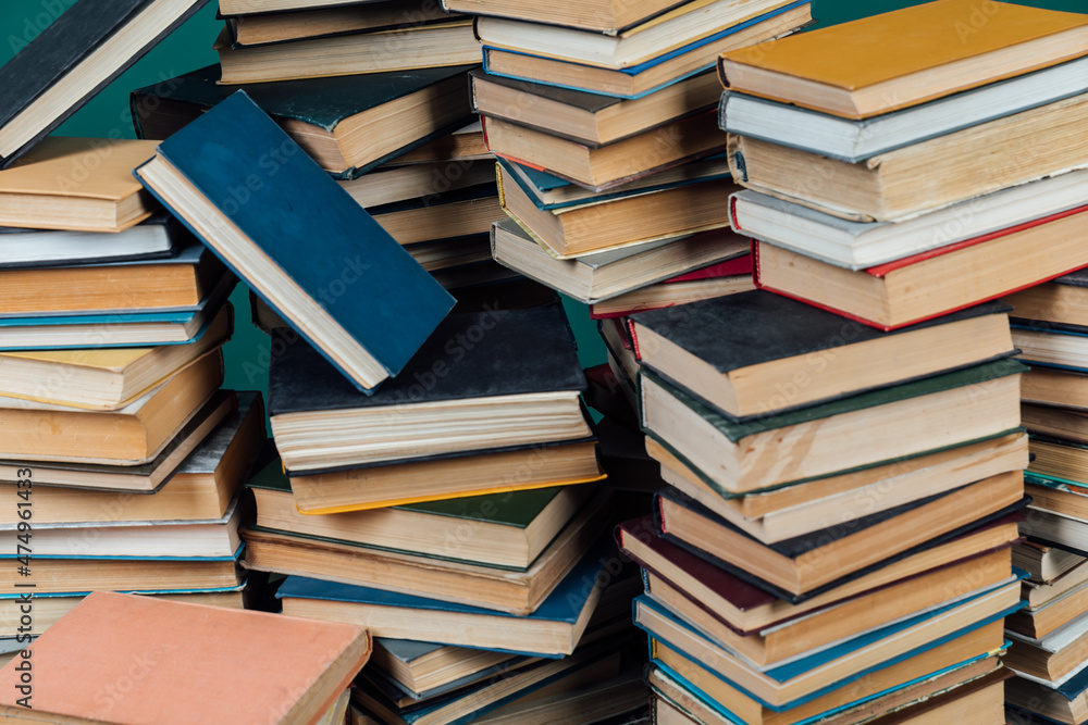 Obraz premium stacks of books for teaching knowledge of the university library green background